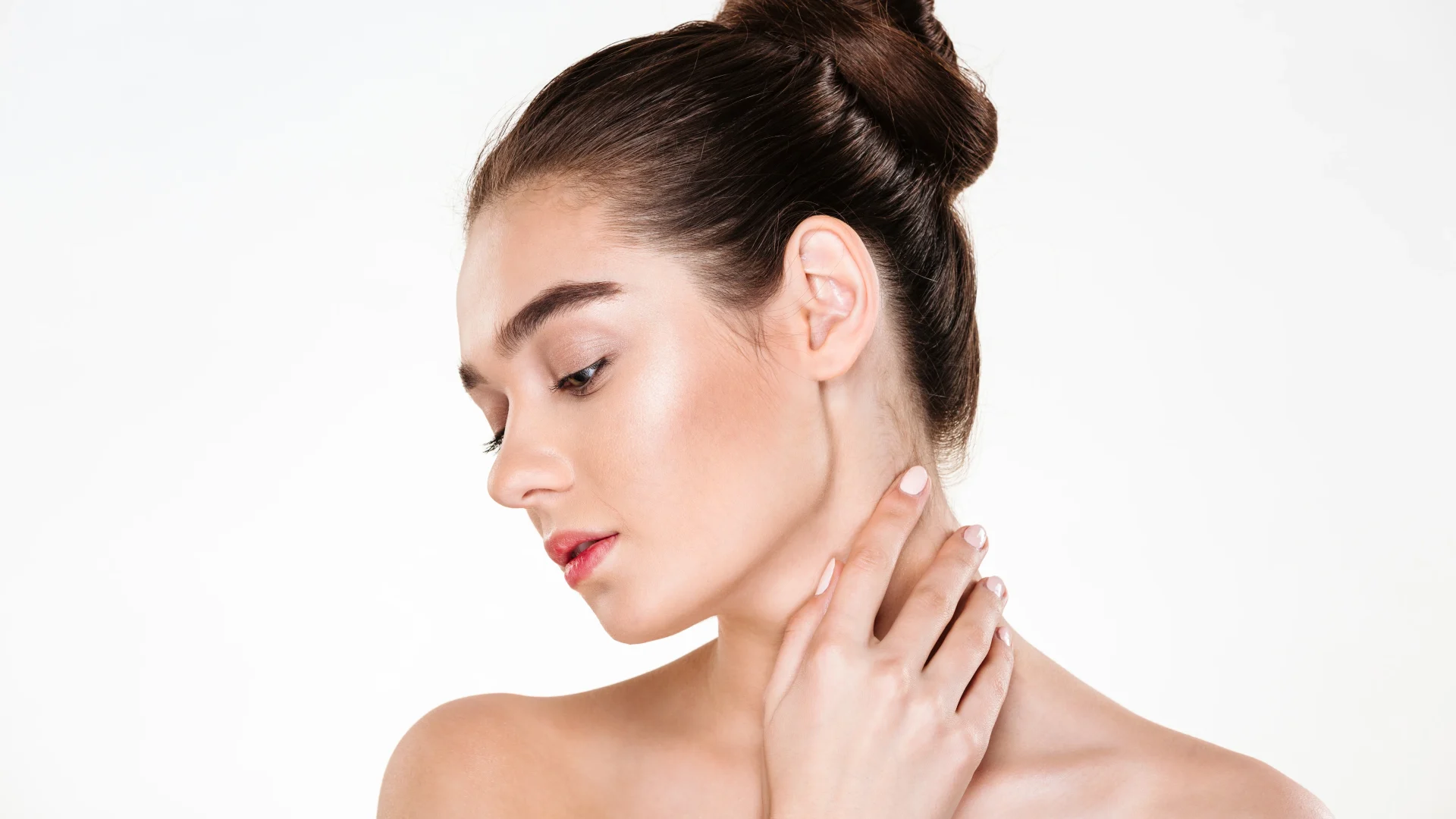 portrait-gentle-young-woman-with-healthy-body-touching-her-neck-posing-with-face-downwards